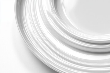 Poster - Minimalist white ceramic plates stacked in elegant curves creating a modern artistic composition with subtle light and shadow play for sophisticated dining