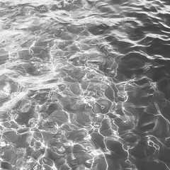 Poster - Serene monochrome water surface with sunlight reflections creating a mesmerizing abstract pattern and tranquil mood
