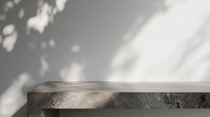 Poster - smooth gray marble tabletop with a soft matte finish, enhanced by delicate shadow overlays on a neutral white wall, creating depth for product displays.
