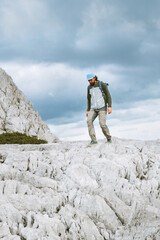 Wall Mural - tourist man hiking solo in greece mountains travel vacations outdoor active healthy lifestyle wild t