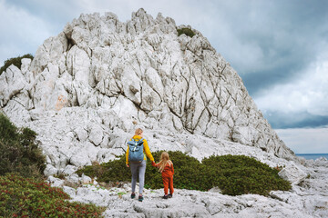 Wall Mural - family child and mother hiking in mountains family travel in greece, mom and daughter walking togeth