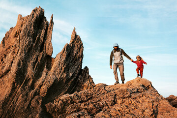 Wall Mural - father hiking with child in rocky mountains family travel adventure vacations active healthy lifesty