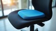 © PremiumPhoto - Gel Seat Cushion. Black office chair with blue memory foam cushion in