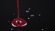 © KIMEHIME - Red liquid pouring, splash, dark background.  Possible use Stock photo for food, drink, or beverage product advertisement
