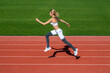 © Yevhen - Fitness woman on stadium, run. Young fitness woman runner running on stadium track. Woman in sportswear jogging on stadium. Sportswoman in sportswear jumping. Woman running jump on stadium track