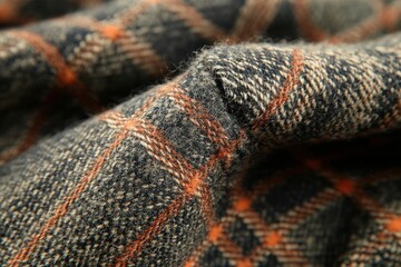 Poster - A detailed close-up of a gray and orange plaid fabric with intricate weave, capturing the texture and design, perfect for background, textile or fashion concepts.