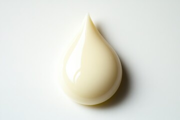 Fototapete - Creamy white drop of liquid resembling natural oils resting on a smooth surface in a well-lit setting