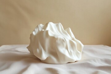 Poster - Unique white sculpture resembling a soft, flowing fabric displayed on a neutral background in a contemporary art setting