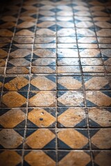 Sticker - A close-up view of a tiled floor with a repeating yellow and black pattern