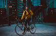 © oneinchpunch - Food delivery rider on his bicycle. Image of a middle age man at work in the city center. Delivering pizza and burgers at home with the thermal backpack.