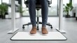 © Yuparet - Employee Sitting Comfortably Using Footrest for Better Posture