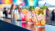 © Vangly - Colorful cocktails with fresh lemon and mint at a vibrant outdoor bar.