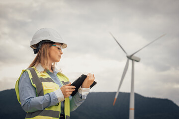 Poster - A skilled female engineer is diligently inspecting a wind turbine at a renewable energy site, focusing on ensuring safety, sustainability, and innovative technologies in the engineering field