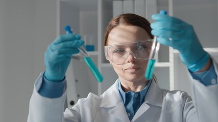 Aufkleber - In a modern laboratory environment, a dedicated scientist is meticulously analyzing various test tubes filled with chemicals. Each test involves careful experimentation, providing crucial insights