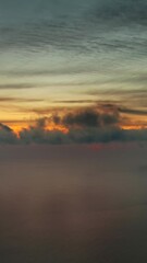 Wall Mural - aerial view of sea surface during a beautiful colourful sunset, timelapse. vertical video