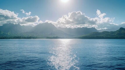 Wall Mural - a tranquil ocean scene featuring mountains and a bright sun reflecting on the water.