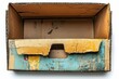 © Suthee - Weathered Cardboard Box: Close-up shot of an empty, old cardboard box, showing wear and tear, revealing a sense of history, reuse, and the journey of packaging.