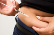 © Fabián Montaño - A diabetic young woman using insulin in stomach. Control diabetes.