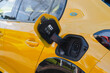 © ADDICTIVE STOCK - Electric car charging with visible plugged-in cable