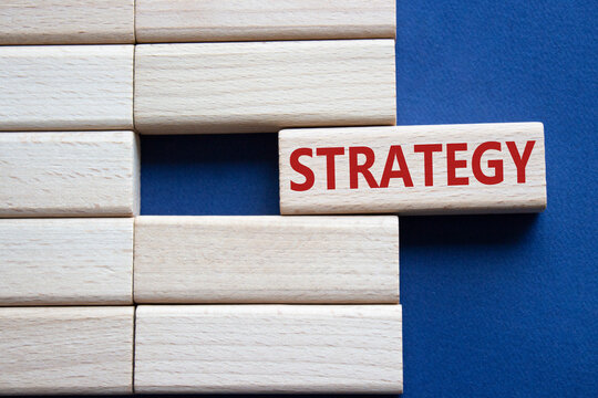 Strategy symbol. Concept word Strategy on wooden blocks. Beautiful deep blue background. Business and Strategy concept. Copy space.