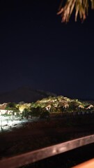 Poster - Landscape with an angle rotated to the left of night sky filled with shooting stars above a mountain