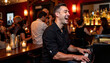 © LunaStar - Joyful jazz pianist performing in lively bar, music and celebration