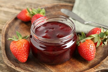 Wall Mural - Delicious strawberry sauce and fresh berries on wooden table, closeup