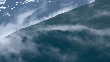 Wall Mural - alaska countryside caught in dense fog on mountains.