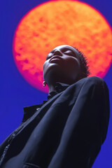 Poster - A Captivating Portrait of Individuality Against a Striking Orange Sunlit Background: Exploring Human Expression and Artistic Photography