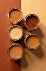 Poster - Five open paint cans in various shades of brown and beige are arranged neatly on a textured background showcasing earthy tones. The colors suggest a focus on design and creativity.