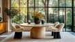 © Pannee - A contemporary round dining table with chairs placed against a large window.