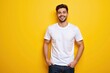 © MT - Smiling Young Hispanic Male in a White T-Shirt Posing Against a Bright Yellow Background, Radiating Positivity and Confidence