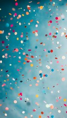 Poster - Colorful circular confetti pieces falling against a bright blue background