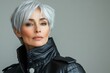 © Odin AI - Stylish woman with short silver hair in a black leather jacket showcasing modern fashion trends indoors