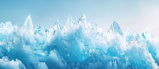 Poster - Icy crystal formations glistening under a blue sky with subtle light reflections, showcasing sharp peaks and textured ice structures on the mountaintop.