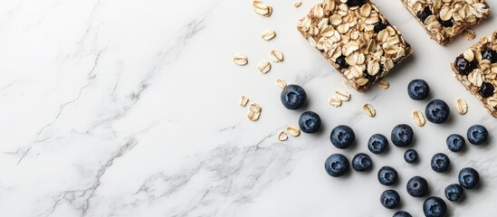 Poster - Healthy superfood breakfast bars made with oats and blueberries on a white marble background with scattered oats and blueberries.