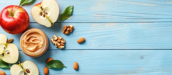 Poster - Fresh red apple slices with creamy peanut butter, nuts, and a knife on a light blue wooden table, arranged for a healthy snack display.