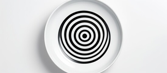 Poster - Ceramic plate with black concentric circles centered on a white background creating an elegant minimalist design ideal for copy space use