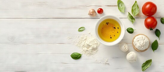 Poster - Homemade pizza ingredients layout on white wooden background featuring flour olive oil mozzarella tomatoes and fresh basil leaves in vibrant colors