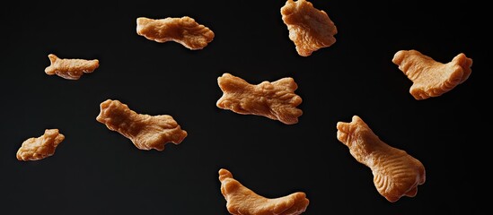 Poster - Golden brown, crispy chicken nuggets flying against a dark background, creating a dynamic and appetizing visual for food advertising.