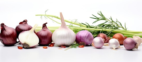 Poster - Colorful assortment of shallots and onions arranged horizontally on a white background with fresh herbs adding green accents to the composition.