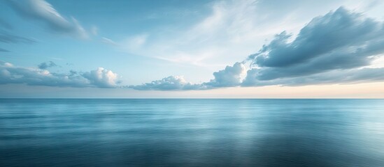 Fototapete - serene seascape at dusk featuring soft blue and turquoise hues with gentle waves, distant clouds and