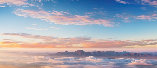 Poster - Early morning sunrise with soft pastel clouds over southern Africa creating a tranquil atmosphere, mountains in the distance and ample copy space.