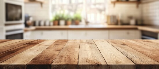 Leinwandbilder - Wooden table in foreground with warm tones against a bright kitchen backdrop featuring shelves and greenery, creating a cozy inviting atmosphere.