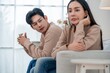 © Hip.hub - Couple sitting in a modern living room during a tense conversation in soft afternoon light