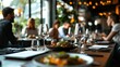 © Justlight - Empty wine glasses and a gourmet meal are set on a restaurant table, creating a sophisticated and inviting dining atmosphere, while in the background, people enjoy their meals and conversations