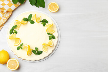 Wall Mural - delicious lemon cheesecake with mint and fresh fruits on white wooden table, flat lay. space for tex