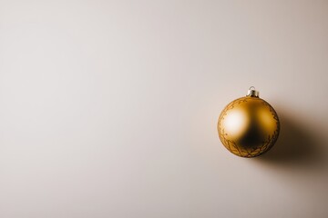 Aufkleber - A single glossy Christmas bauble featuring detailed gold patterns rests on a white background, creating a festive atmosphere while offering ample copy space