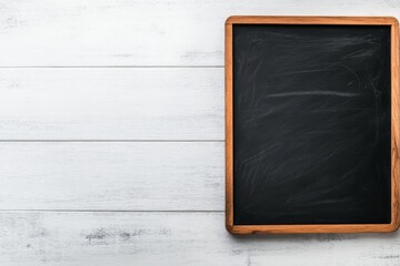 Poster - A rectangular blackboard lies on a white surface, featuring faint chalk marks. It provides ample space for writing and creative expressions or educational themes