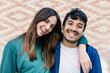 © Xavier Lorenzo - Young multiracial couple smiling at camera standing together outdoor. Headshot of two diverse Latin American friends laughing